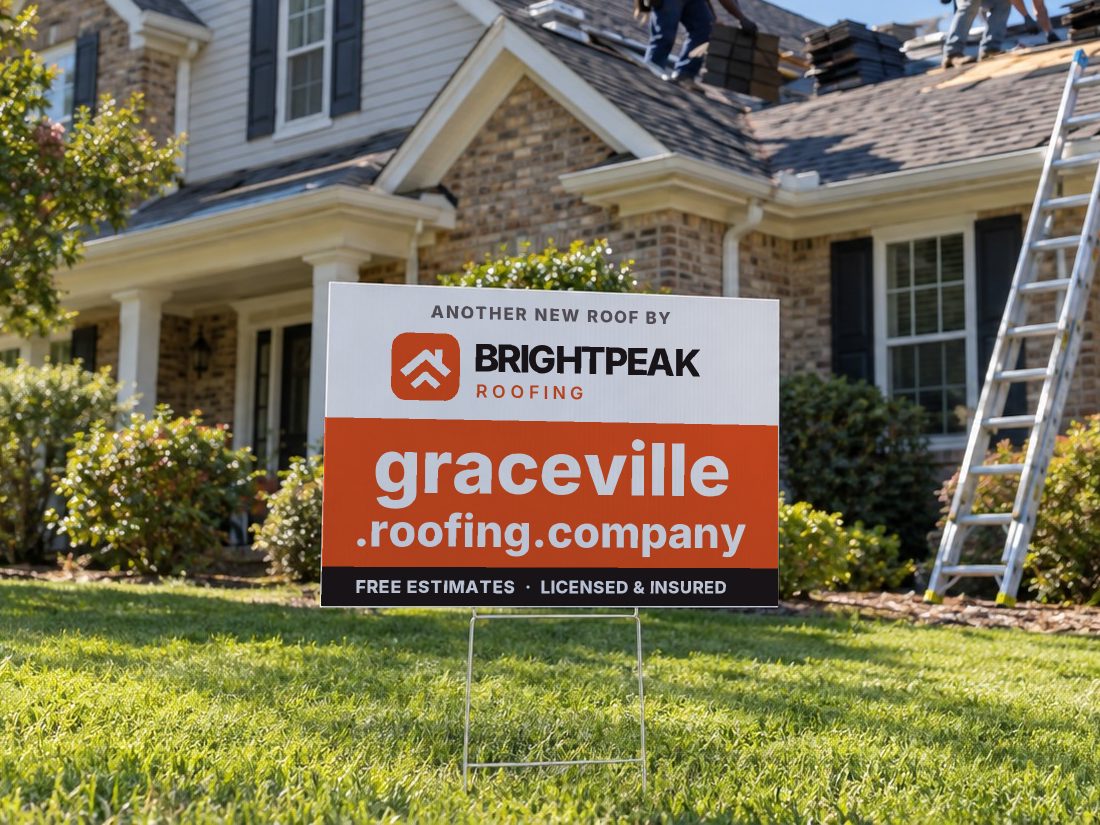 graceville.roofing.company on a yard sign in front of a house getting a new roof